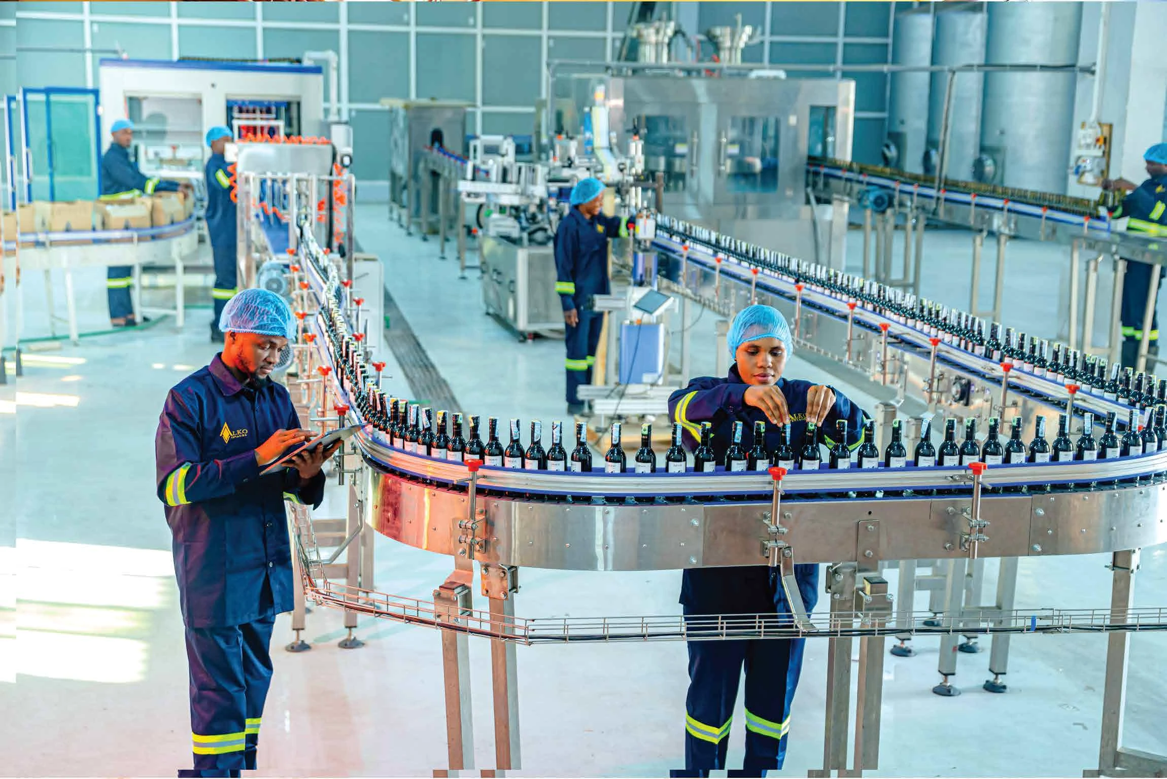 Alko production team monitoring wine bottles on the bottling line